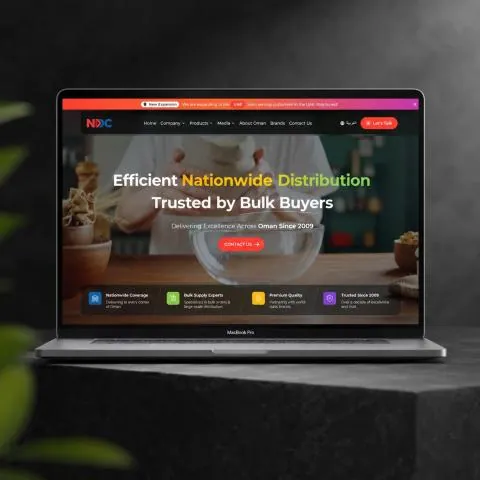 NDC Oman corporate website on a laptop, developed by Lalit Jakhar for National Distribution Company